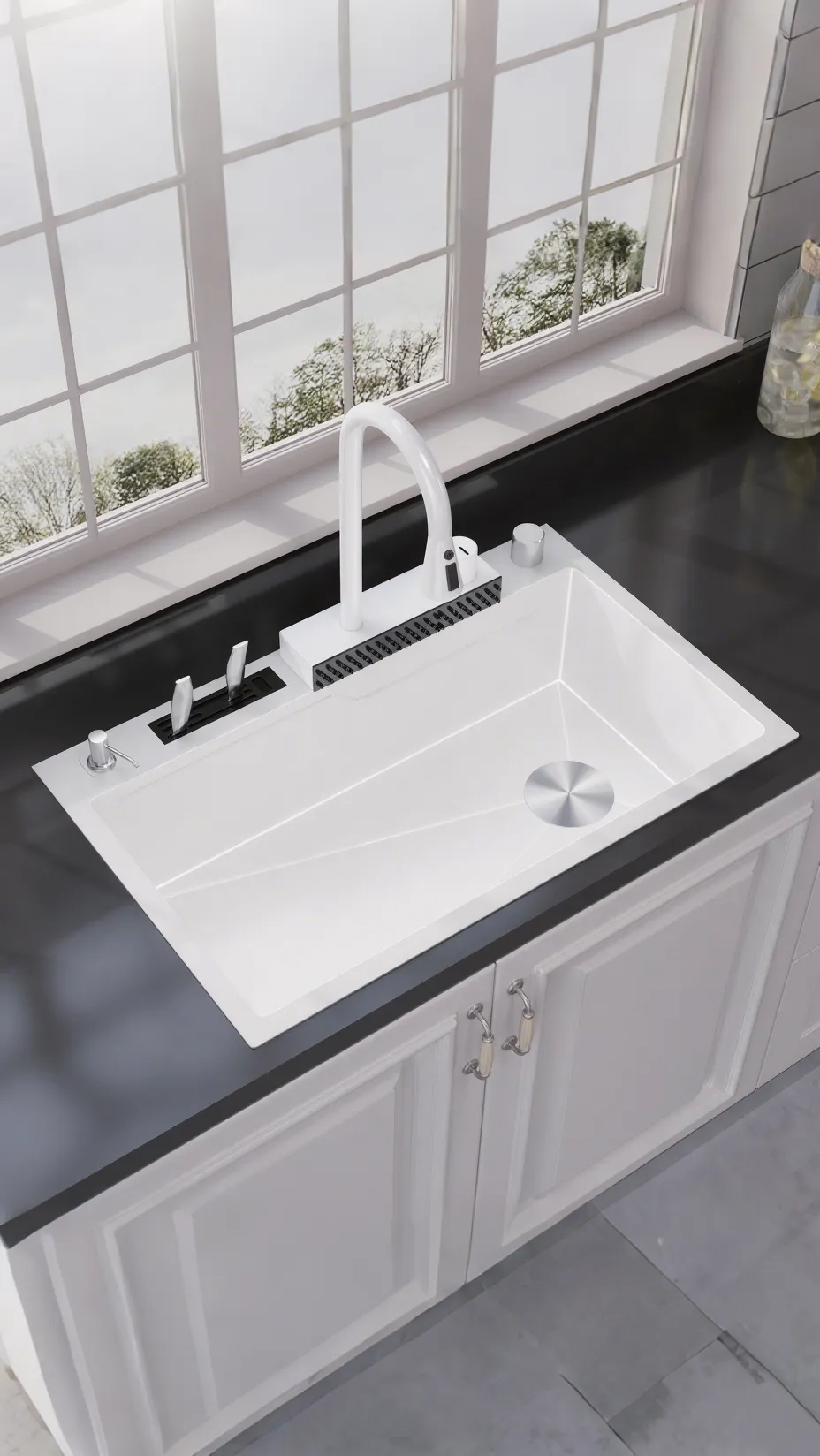 Modern kitchen with rectangular stainless steel sink embedded in white countertop with wooden cabinets below, silver faucet, and kitchen items including plates and bottles